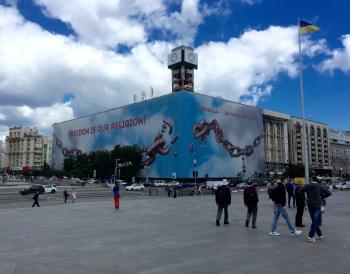 A billboard covers the burned-out Trade Unions Building adjacent to Kiev’s Independence Square.